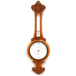 Edwardian carved oak aneroid barometer with thermometer,