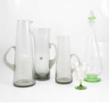 Three Swedish glass water jugs, smoky glass, and other decanter set