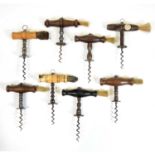 Eight Henshall type corkscrews with brush handles,