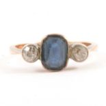 A diamond and blue stone ring.