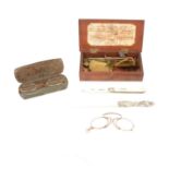 Yellow metal spectacles, folding pince nez, fruit knife, page turner, and apothecary scales.