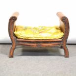 An early 20th century leather covered wooden footstool,