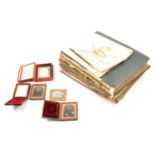 Two albums of postcards and a small number of loose photographic portraits and daguerreotypes