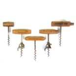 Two Walker bell cap corkscrews and three advertising corkscrews,