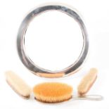 Silver plated dressing table mirror and three brushes,