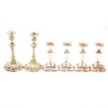 Pair of silver plated candlesticks and a set of four silver plated candlesticks,