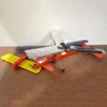 Three model aircraft airframes, with small glow engine