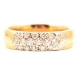 An 18 carat yellow gold band set with diamonds.