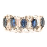 A sapphire and diamond half hoop ring.