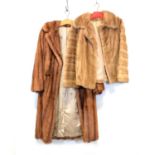 A tan mink coat, a brown mink stole and a light fur jacket.