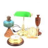 An oil lamp, desk lamp, clocks.