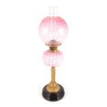 Victorian brass oil lamp, strawberry tinted opaque reservoir