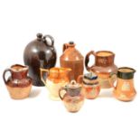 A collection of Doulton stoneware harvest jugs and similar, Markham & Roberts ale flagon etc