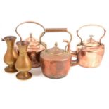 Three copper kettles and a pair of Jones and Willis ecclesiastical brass vases.