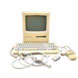 Apple Macintosh Plus computer, with keyboard, mouse and cables.