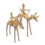 Two African gilt metal figures on horseback,