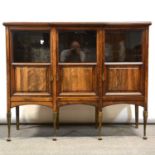 Edwardian breakfront rosewood display cabinet, three doors, on gilt metal legs.