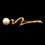 A modern cultured pearl and diamond brooch.