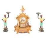 French gilt spelter and porcelain mantel clock, and a pair of spelter candlesticks,