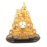 French gilt metal mantel clock on a plinth,