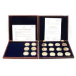 Eight wooden coin cases containing gold plated and printed commemorative coins,