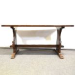 Oak trestle dining table, and a set of eight reproduction ladder-back dining chairs