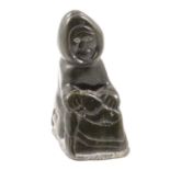 Inuit carved stone seated figure,