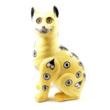 Wemyss pottery cat, yellow ground, retailed by Thomas Goode, missing one foot, 34cm.Condition