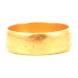 A 22 carat yellow gold wedding band.