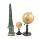 Two reproduction table globes and a variegated hardstone obelisk,