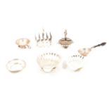 A silver toast rack, butter dishes, two tea strainers.