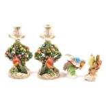Pair of Continental porcelain candlesticks and two birds models,