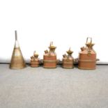 Four brass and copper metric measure petrol cans, and a copper funnel,