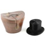 An early 20th century black silk plush top hat, in a leather case