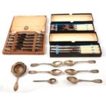 A cased set of silver handled tea knives, 800 tea strainer and teaspoons, xylonite knives.