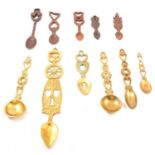 A collection of wooden and brass Welsh love spoons
