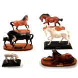Six Beswick horse models on wooden plinths.