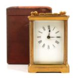 Brass carriage clock and leather carrying case.