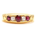 A ruby and diamond half hoop ring.