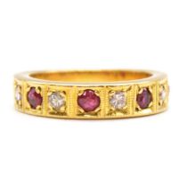 A ruby and diamond half eternity ring.