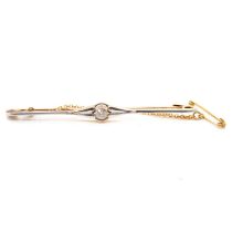 A diamond set bar brooch.