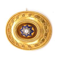 A Victorian yellow metal Etruscan style target brooch with diamond set enamel star to centre.