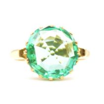 A synthetic emerald solitaire ring.