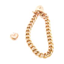 A yellow metal hollow curb link bracelet and heart charm.