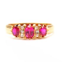 A synthetic ruby and diamond half hoop ring.