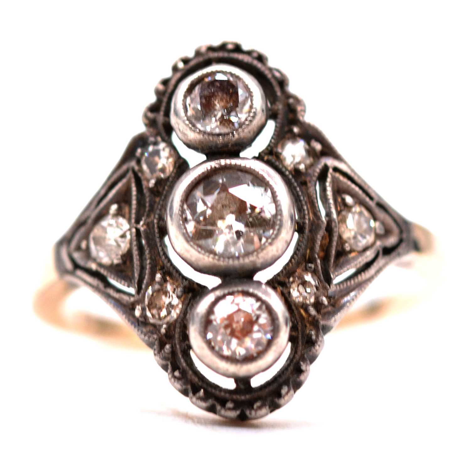 A diamond three stone ring in the Art Deco style.
