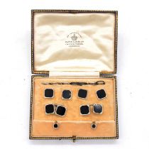 A cased set of black onyx cufflinks and dress studs.