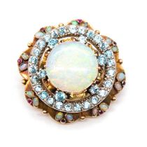 An opal, blue zircon and ruby circular target brooch.