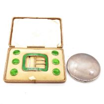 A cased set of green guilloche enamel buttons and buckle, a silver compact.