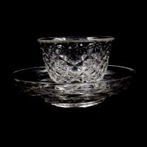 A cut glass tea bowl and saucer